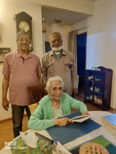 Mrs Cherian being presented a copy of Ingathering Book December 2020